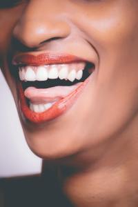dark skinned woman with white teeth and red lips