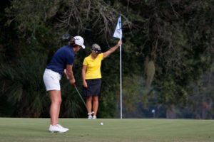 women playing golf